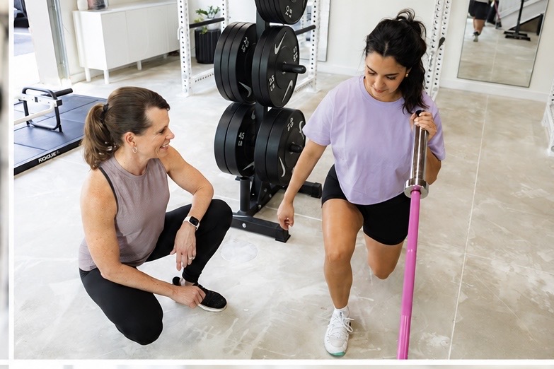 Cherie coaching a client through a lunge exercise